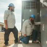 Houston Electric History and Team working on a breaker box